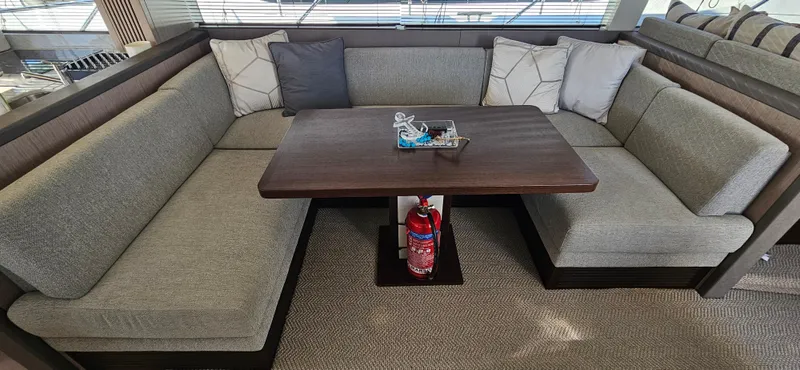  Yacht Photos Pics Luxurious seating area on 2019 Sunseeker Manhattan 66 yacht with elegant cushions and table.