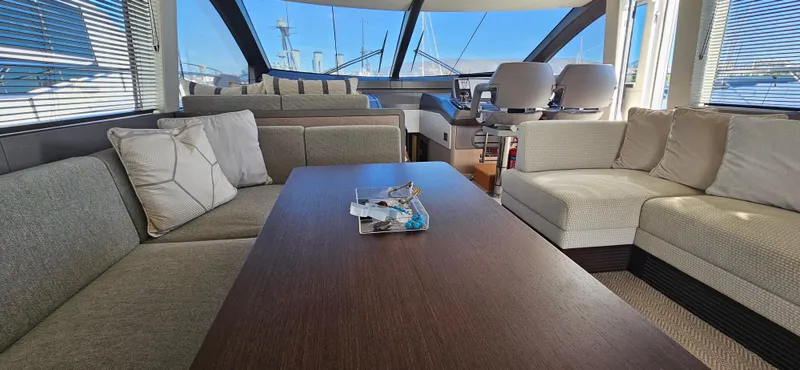  Yacht Photos Pics Luxurious interior of 2019 Sunseeker Manhattan 66 yacht with plush seating and panoramic windows.