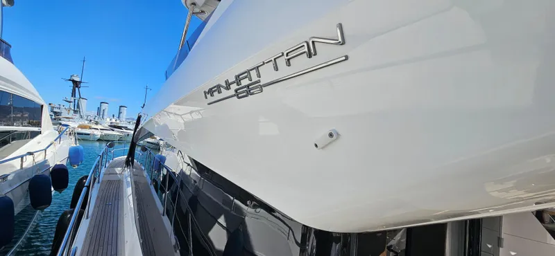  Yacht Photos Pics 2019 Sunseeker Manhattan 66 yacht docked in marina, showcasing sleek design and branding.