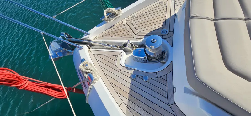  Yacht Photos Pics 2019 Sunseeker Manhattan 66 yacht deck with winch and seating, on calm water.