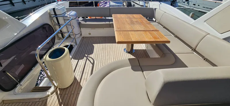  Yacht Photos Pics Luxurious Sunseeker Manhattan 66 yacht deck with seating and wooden table, 2019 model.