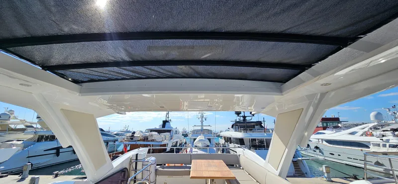  Yacht Photos Pics 2019 Sunseeker Manhattan 66 yacht deck with marina view and seating area.