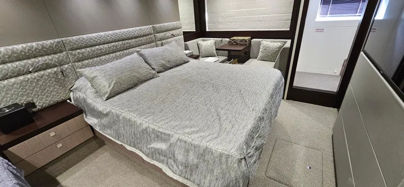  Yacht Photos Pics Luxurious bedroom interior of 2019 Sunseeker Manhattan 66 yacht with elegant bedding and seating area.