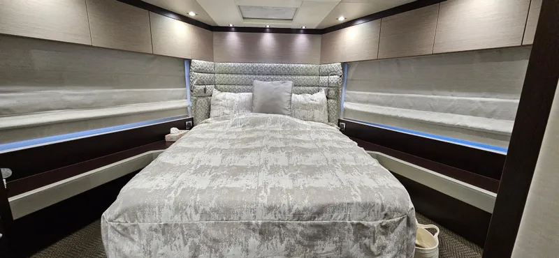  Yacht Photos Pics Luxurious bedroom interior of 2019 Sunseeker Manhattan 66 yacht with elegant bedding and ambient lighting.