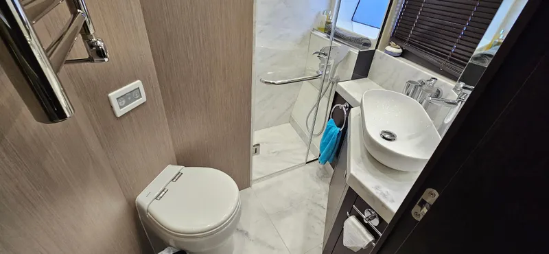  Yacht Photos Pics Luxurious bathroom in 2019 Sunseeker Manhattan 66 yacht with modern fixtures and elegant design.