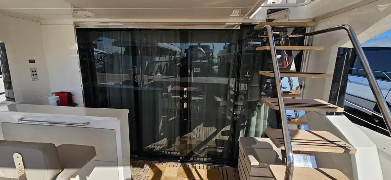  Yacht Photos Pics 2019 Sunseeker Manhattan 66 yacht interior with stairs and glass doors.