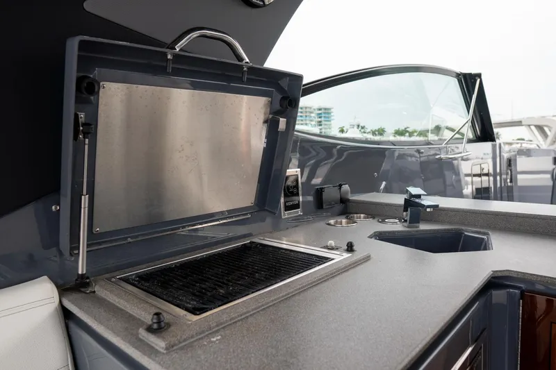 Di Blue Yacht Photos Pics Outdoor kitchen area on 2022 Cruisers Yachts 38 GLS, featuring a grill and sink.
