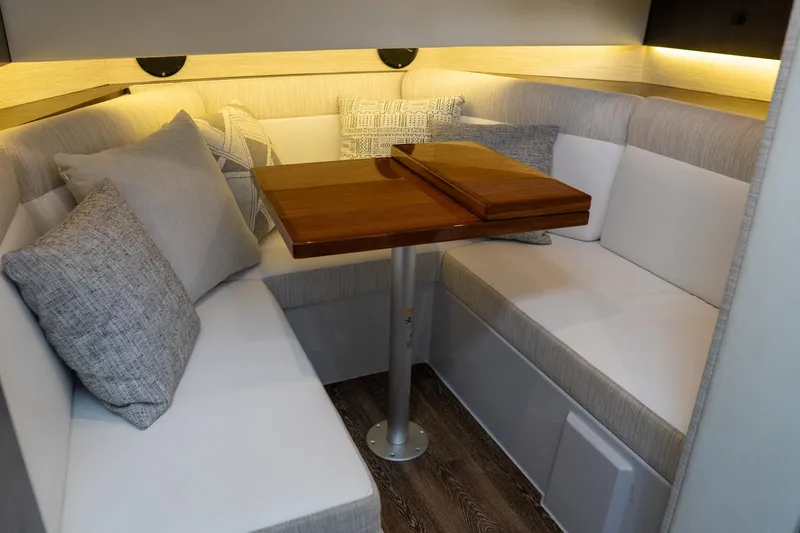 Di Blue Yacht Photos Pics 2022 Cruisers Yachts 38 GLS interior with cozy seating and wooden table.