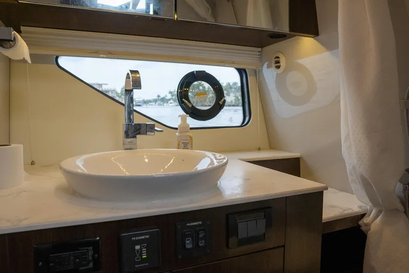 Di Blue Yacht Photos Pics 2022 Cruisers Yachts 38 GLS bathroom with modern sink and window view.
