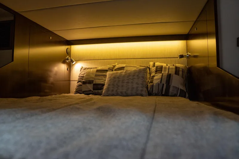 Di Blue Yacht Photos Pics 2022 Cruisers Yachts 38 GLS cabin interior with cozy bed and ambient lighting.