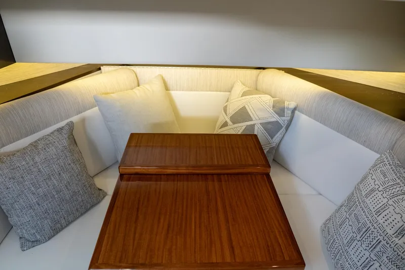 Di Blue Yacht Photos Pics 2022 Cruisers Yachts 38 GLS interior with cushioned seating and wooden table.