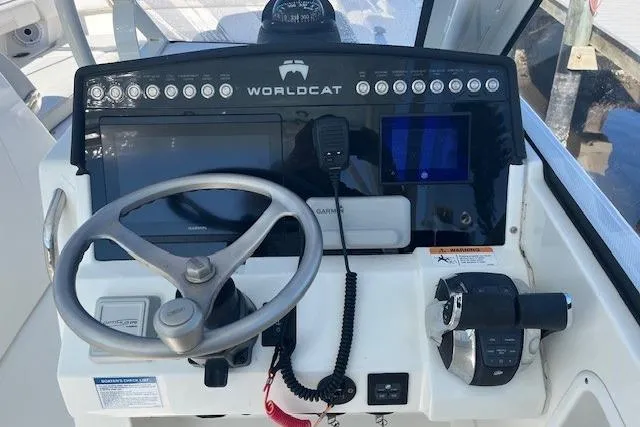  Yacht Photos Pics 2024 World Cat 280 DC-X helm with steering wheel, controls, and navigation equipment.