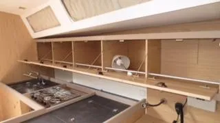 Maelstrom Yacht Photos Pics Interior of 2017 Beneteau Oceanis 45 yacht kitchen with open cabinets and stove.