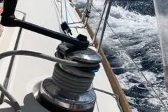 Maelstrom Yacht Photos Pics Sailing on a 2017 Beneteau Oceanis 45, winch in action, ocean waves in background.