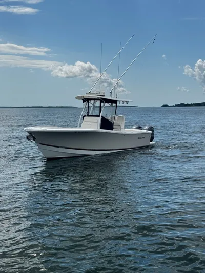  Yacht Photos Pics 2015 Regulator 25 boat on calm water under a clear blue sky.