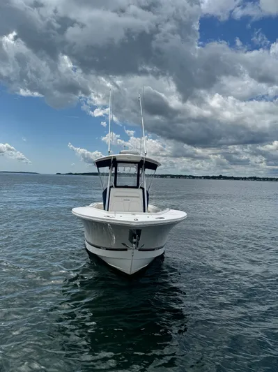 Yacht Photos Pics 2015 Regulator 25 boat on open water under cloudy sky.