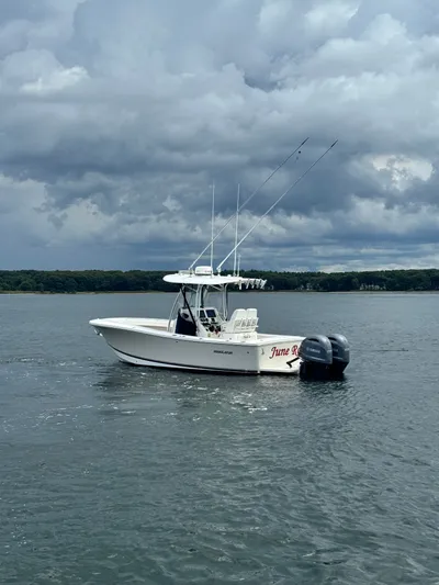  Yacht Photos Pics 2015 Regulator 25 boat on water under cloudy sky.