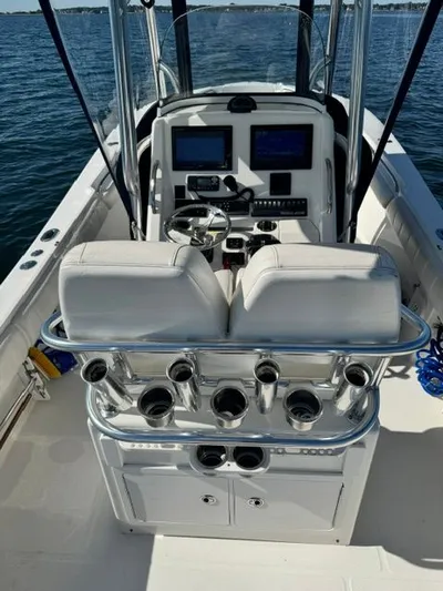  Yacht Photos Pics 2015 Regulator 25 boat cockpit with dual seats and control panel on open water.