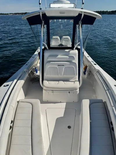  Yacht Photos Pics 2015 Regulator 25 boat interior with seating, on calm water.