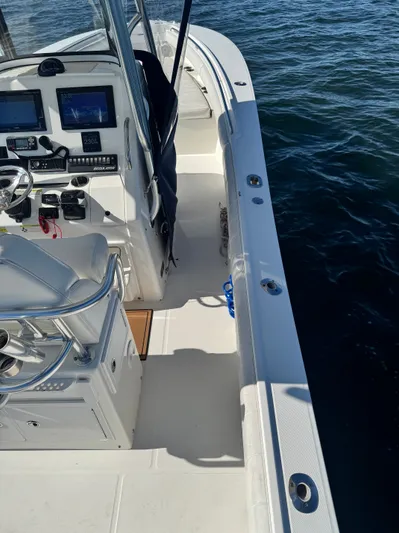  Yacht Photos Pics 2015 Regulator 25 boat interior with steering console and navigation equipment.