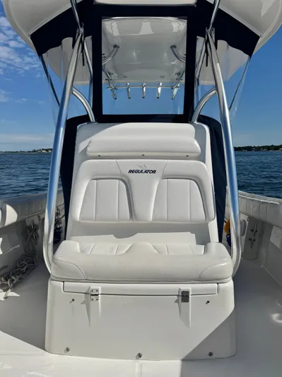  Yacht Photos Pics 2015 Regulator 25 boat interior with white seating and ocean backdrop.