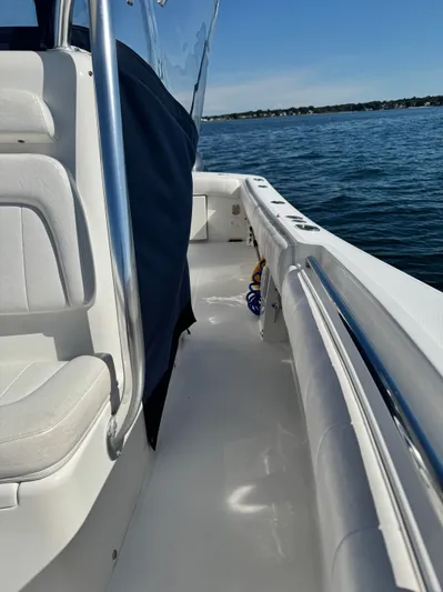  Yacht Photos Pics 2015 Regulator 25 boat interior with white seating, chrome railing, and ocean view.