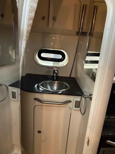  Yacht Photos Pics 2016 Sea Ray 330 Sundancer bathroom with sink and porthole window.