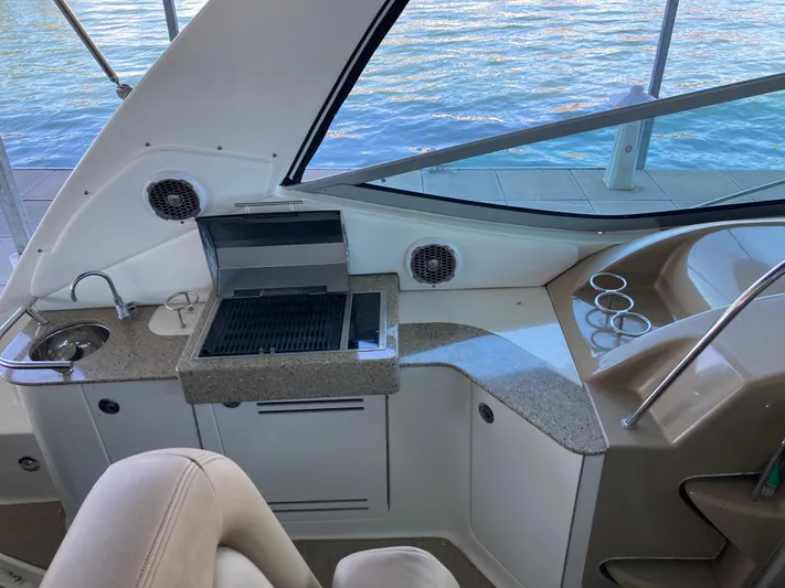  Yacht Photos Pics 2016 Sea Ray 330 Sundancer yacht interior with grill and sink, overlooking water.