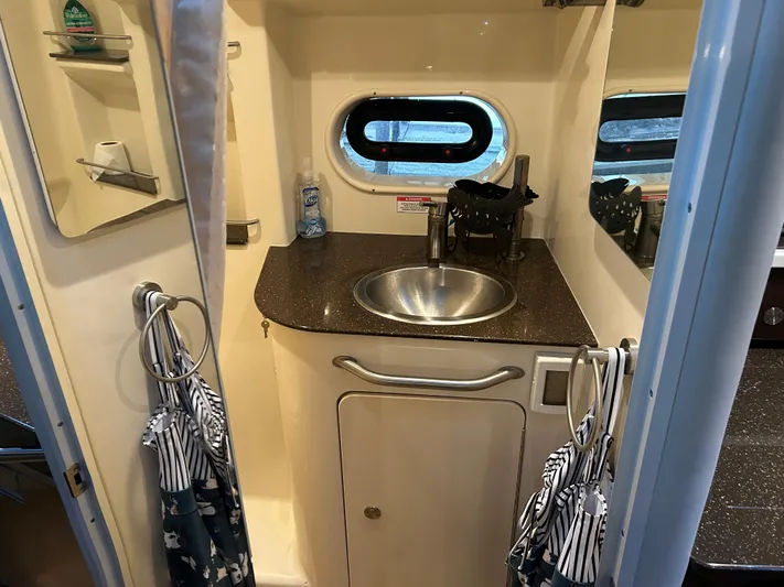  Yacht Photos Pics 2016 Sea Ray 330 Sundancer bathroom with sink, mirror, and window.