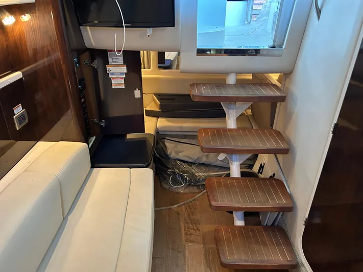  Yacht Photos Pics Interior of 2016 Sea Ray 330 Sundancer with wooden steps and white seating.
