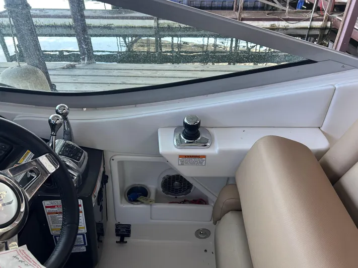  Yacht Photos Pics Interior view of a 2016 Sea Ray 330 Sundancer boat cockpit with steering controls.