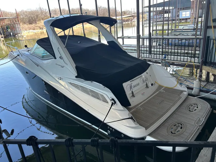  Yacht Photos Pics 2016 Sea Ray 330 Sundancer docked, featuring sleek design and covered seating area.