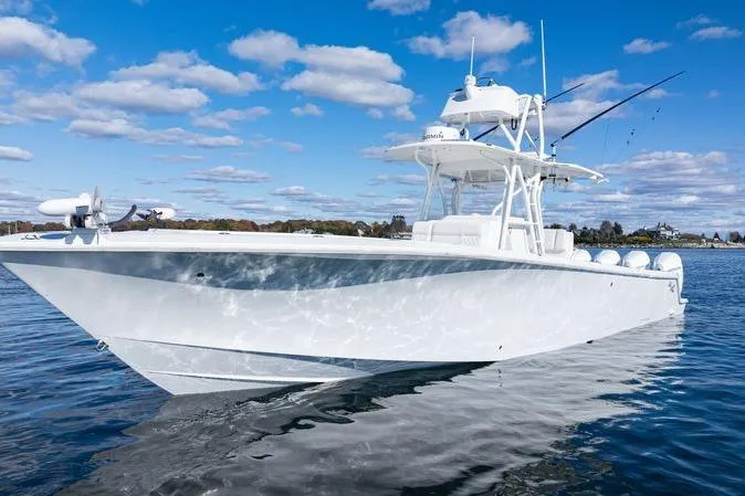  Yacht Photos Pics 2016 SeaVee 390Z boat on calm water under a blue sky with clouds.