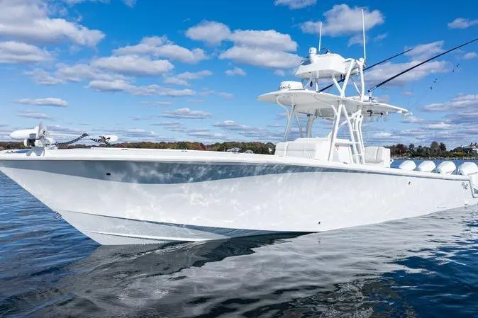  Yacht Photos Pics 2016 SeaVee 390Z boat on calm water under a blue sky with clouds.