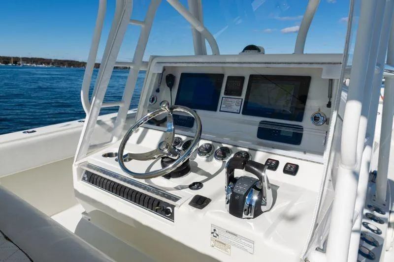  Yacht Photos Pics 2016 SeaVee 390Z boat console with steering wheel and navigation screens on open water.