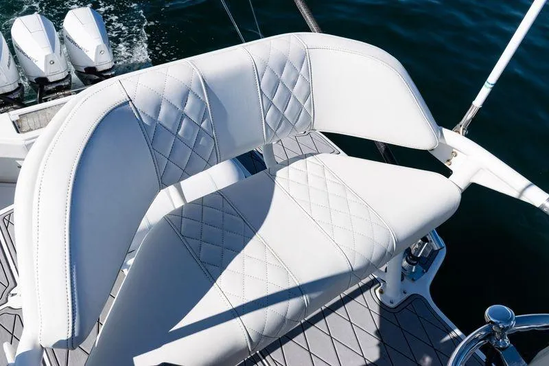  Yacht Photos Pics White leather seating on 2016 SeaVee 390Z boat, with triple outboard motors in background.