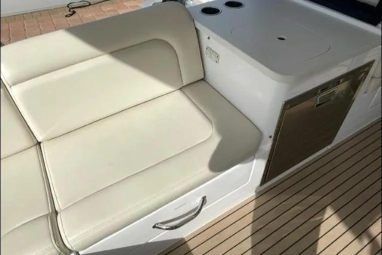 Lucky Boys Yacht Photos Pics 2022 MJM 3 boat interior with beige seating and built-in storage.