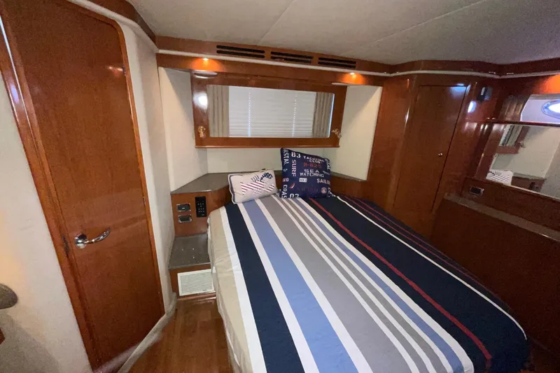 Club Level Yacht Photos Pics Luxurious cabin interior of 2002 Sea Ray 480 Motor Yacht with striped bedding.