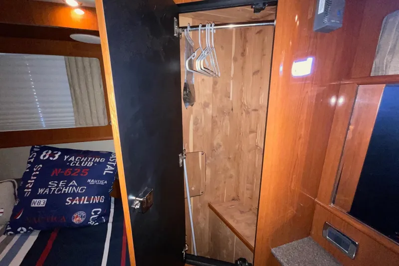Club Level Yacht Photos Pics Interior of 2002 Sea Ray 480 Motor Yacht with open wooden closet and nautical-themed decor.