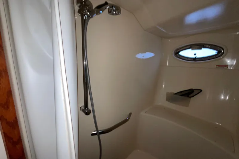 Club Level Yacht Photos Pics Shower area in 2002 Sea Ray 480 Motor Yacht with porthole and chrome fixtures.