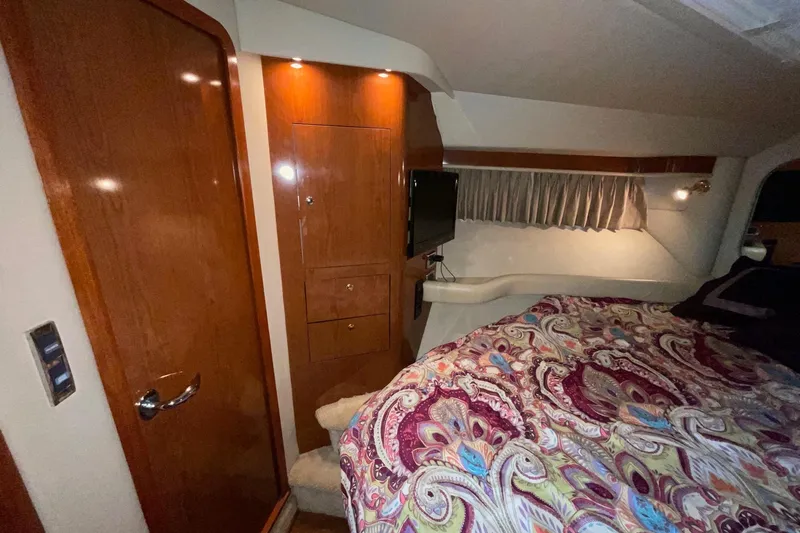 Club Level Yacht Photos Pics Luxurious 2002 Sea Ray 480 Motor Yacht cabin with wood paneling and patterned bedding.