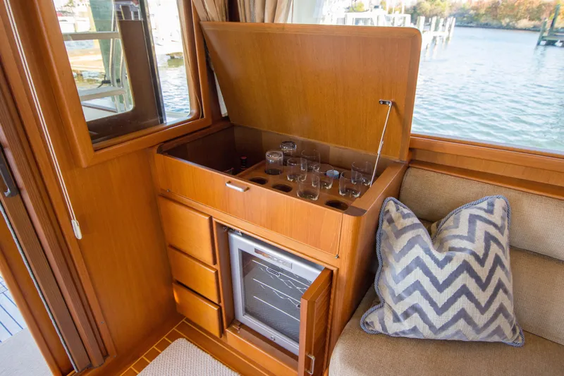  Yacht Photos Pics Interior of 2013 Fleming 55 yacht with bar cabinet and chevron pillow.