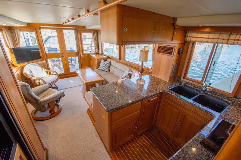  Yacht Photos Pics Luxurious interior of a 2013 Fleming 55 yacht with elegant wood finishes and waterfront views.