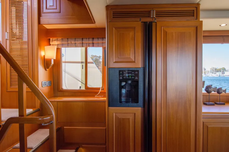  Yacht Photos Pics Luxurious wooden interior of a 2013 Fleming 55 yacht with a built-in refrigerator.