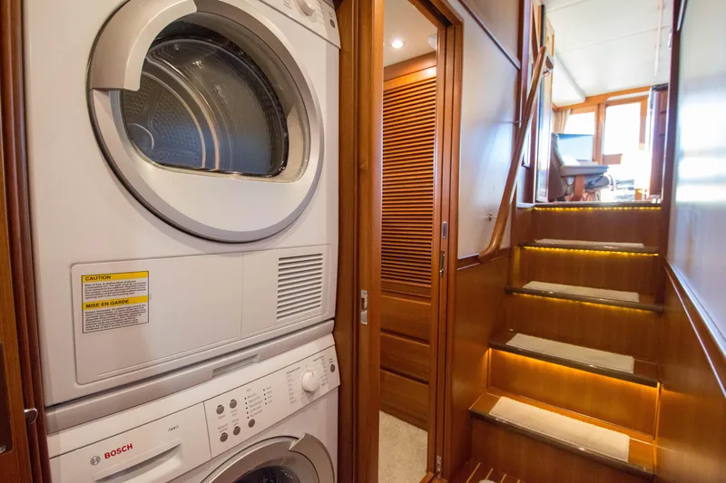  Yacht Photos Pics Laundry area and staircase in 2013 Fleming 55 yacht interior, featuring Bosch appliances.