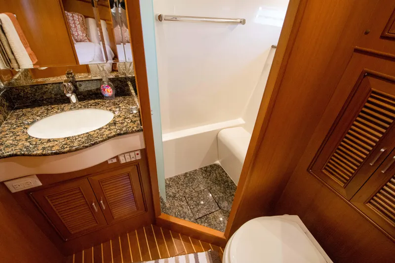  Yacht Photos Pics Luxurious bathroom in 2013 Fleming 55 yacht with granite countertop and wooden cabinetry.