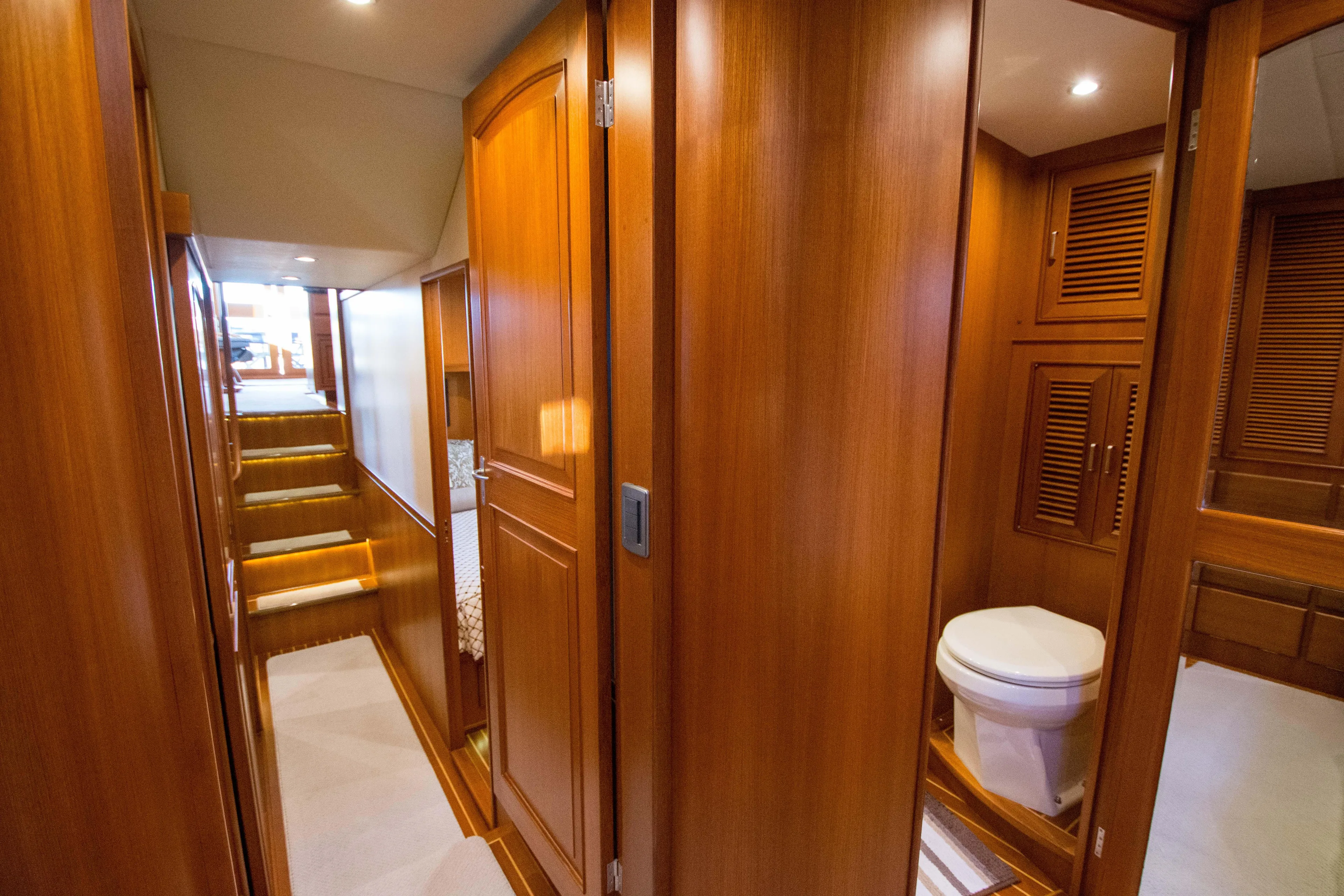  Yacht Photos Pics Luxurious wooden interior of 2013 Fleming 55 yacht, featuring hallway and bathroom.