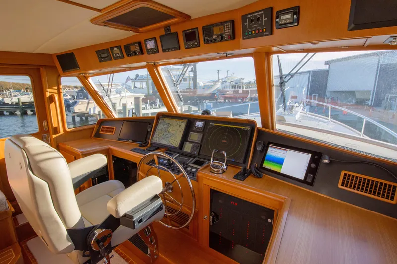  Yacht Photos Pics Luxurious 2013 Fleming 55 yacht helm with advanced navigation systems and panoramic marina view.