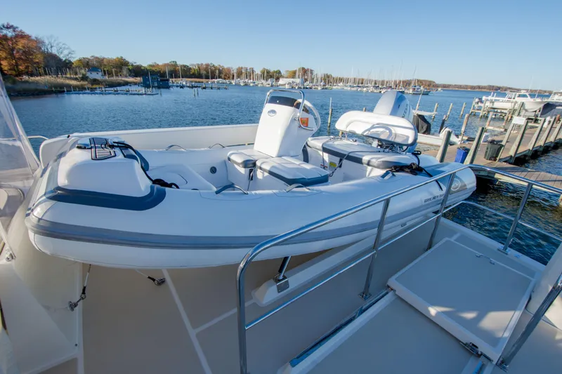  Yacht Photos Pics 2013 Fleming 55 yacht with inflatable boat on deck, docked at marina.