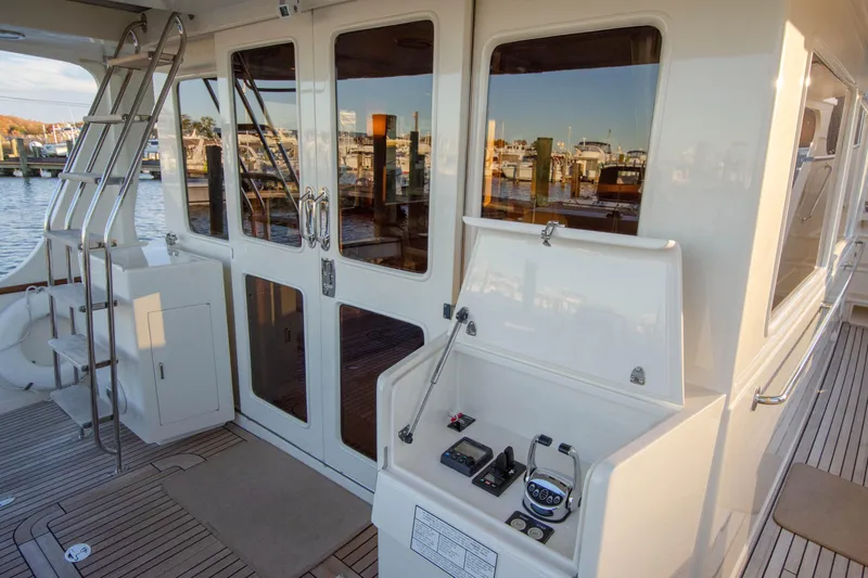  Yacht Photos Pics Luxurious 2013 Fleming 55 yacht deck with control panel and marina view.